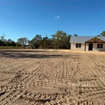 Excavated and graded residential building site with compacted soil and visible grading patterns