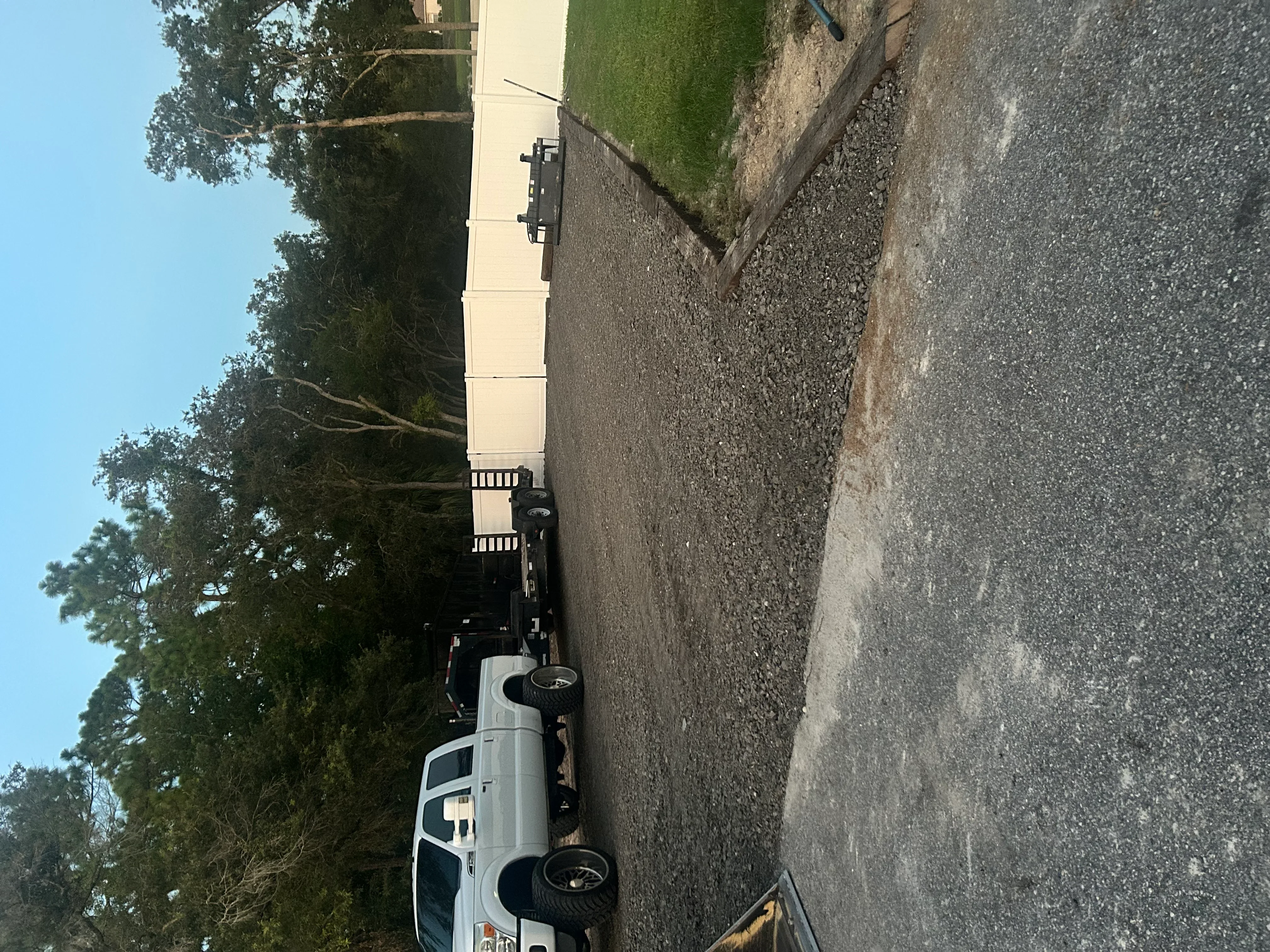 Excavated and graded driveway with compacted base material and finished edges