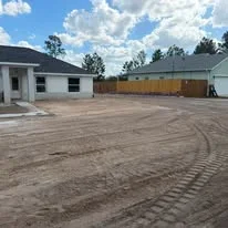 Excavated and graded commercial lot with compacted soil and equipment tracks